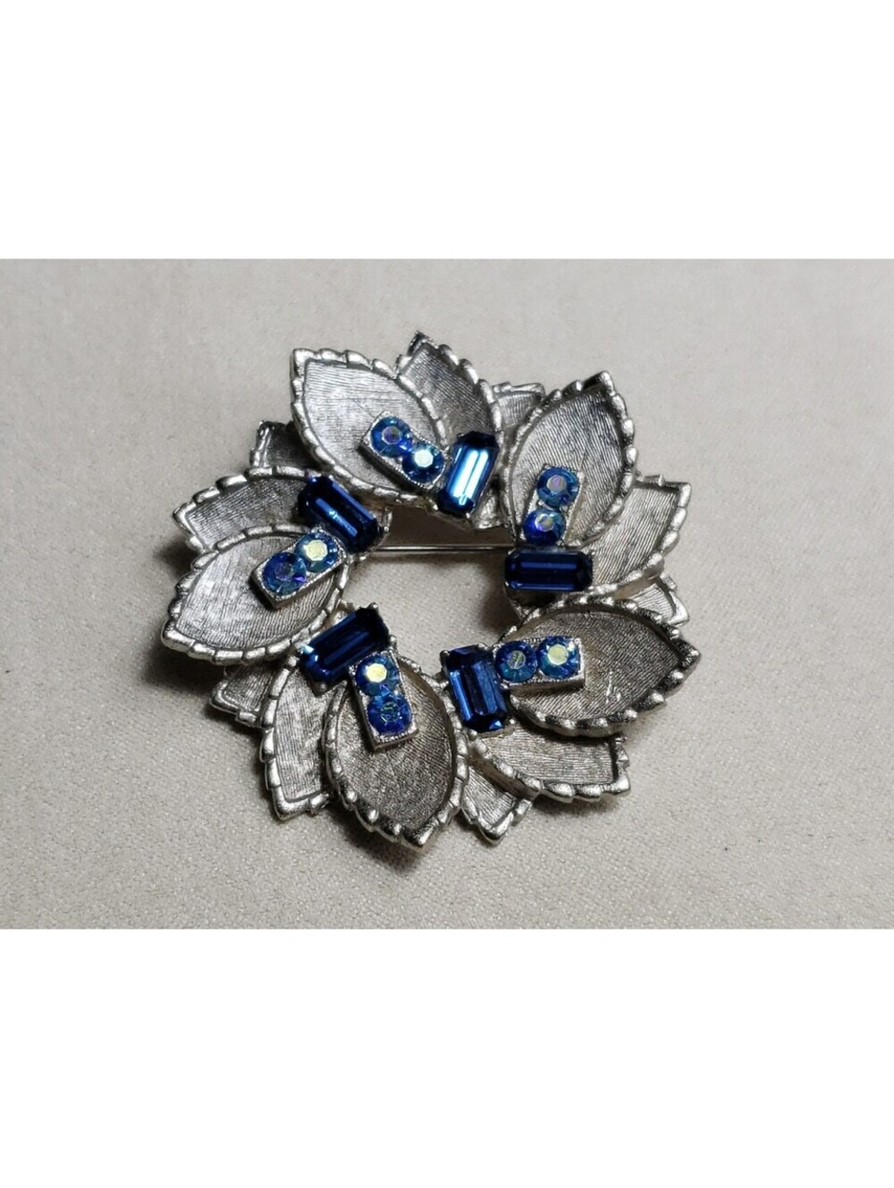 Vintage BSK Brooch Brushed Silver Tone Metal Petals with Blue Rhinestones Wreath